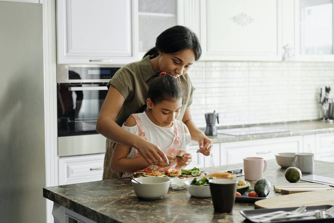 Free Mother and Daughter Preparing Avocado Toast Stock Photo