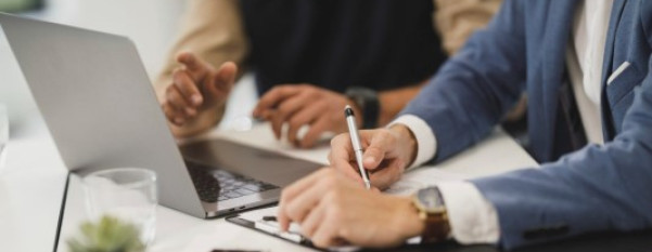 Two people working on a laptop