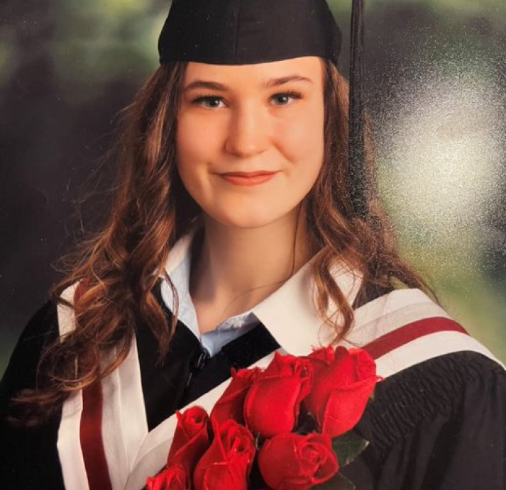 Olivia Cann wearing a graduation cap and gown