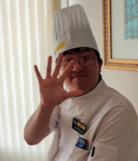 Anthony Go smiling and waving to the camera