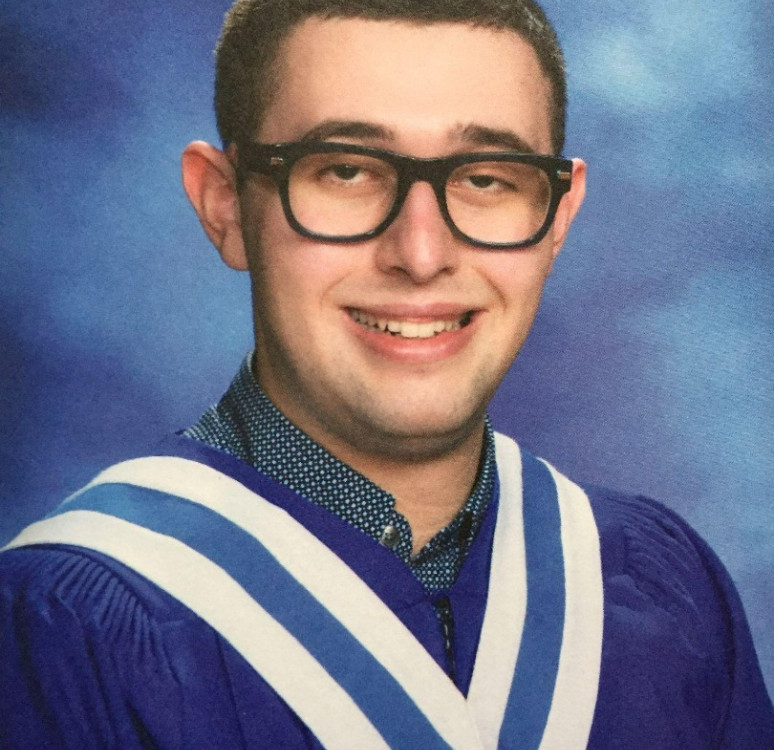 Joshua Dargie wearing a graduation gown