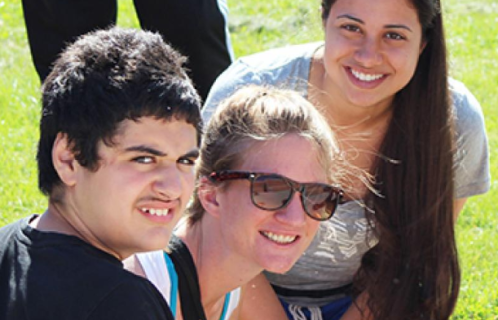 Image of three young people outside on a sunny day