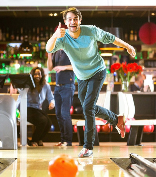adult bowling in the lane