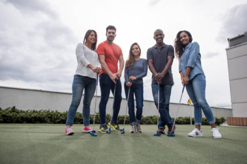Group of adults holding gold clubs