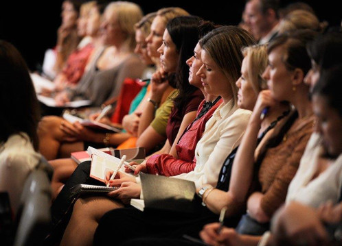 A group of people listening to a speaker