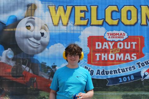Connor in front of Thomas & Friends Banner